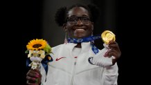 Gold medalist, United States Tamyra Marianna Stock Mensah celebrates on the podium during the medal ceremony for the women's 68kg Freestyle wrestling at the 2020 Summer Olympics, Tuesday, Aug. 3, 2021, in Chiba, Japan.