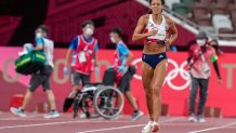 Katarina Johnson-Thompson, of Britain, finishes a heat of the heptathlon women's 200-meter at the Tokyo Olympics after falling from an injury, Wednesday, Aug. 4, 2021, in Tokyo. Johnson-Thompson, the defending world champion, refused a wheelchair and finished the heat on her injured leg.