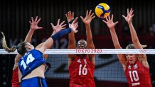 Italy's Elena Pietrini hits the ball in front of USA's Foluke Akinradewo and Jordan Larson in the women's preliminary round pool B volleyball match between USA and Italy during the Tokyo 2020 Olympic Games at Ariake Arena in Tokyo on Aug. 2, 2021.