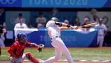 USA's Triston Casas (R) hits a two run home run during the first inning of the Tokyo 2020 Olympic Games baseball round 2 repechage game between Dominican Republic and USA at Yokohama Baseball Stadium in Yokohama, Japan, on Aug. 4, 2021.