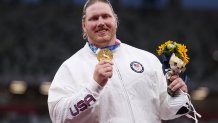 Gold medalist Ryan Crouser of Team United States holds up his medal on the podium during the medal ceremony for the Men’s Shot Put on day thirteen of the Tokyo 2020 Olympic Games at Olympic Stadium on August 05, 2021 in Tokyo, Japan.