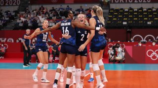 Foluke Akinradewo #16, Jordyn Poulter #2 and Andrea Drews #11 of Team United States celebrate while competing against Team Serbia during the Women's Semifinals on day fourteen of the Tokyo 2020 Olympic Games at Ariake Arena on August 06, 2021 in Tokyo, Japan.