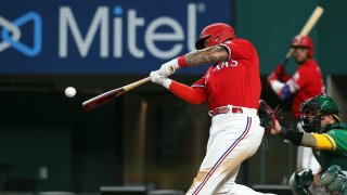 Yohel Pozo #37 of the Texas Rangers hits a three-run home run in the sixth inning against the Oakland Athletics at Globe Life Field on August 13, 2021 in Arlington, Texas.
