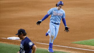 Jonah Heim #28 of the Texas Rangers reacts after hitting a walk off solo home run to defeat the Seattle Mariners 4-3 at Globe Life Field on Aug. 1, 2021 in Arlington, Texas.