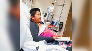 This 2021 photo provided by Yessica Gonzalez shows her son, Francisco Rosales, 9, in the intensive care unit at Children’s Medical Center in Dallas, Texas. The day before he was supposed to start fourth grade, Francisco was admitted to the hospital due to severe COVID-19, struggling to breathe, with dangerously low oxygen levels and an uncertain outcome.