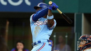 Adolis Garcia #53 of the Texas Rangers hits a grand slam against the Houston Astros in the fifth inning at Globe Life Field on Aug. 29, 2021 in Arlington, Texas.