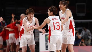 Japanese players celebrate during the women's semifinal contest against France.