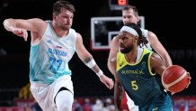 Patty Mills dribbles the ball past Slovenia's Luka Doncic.