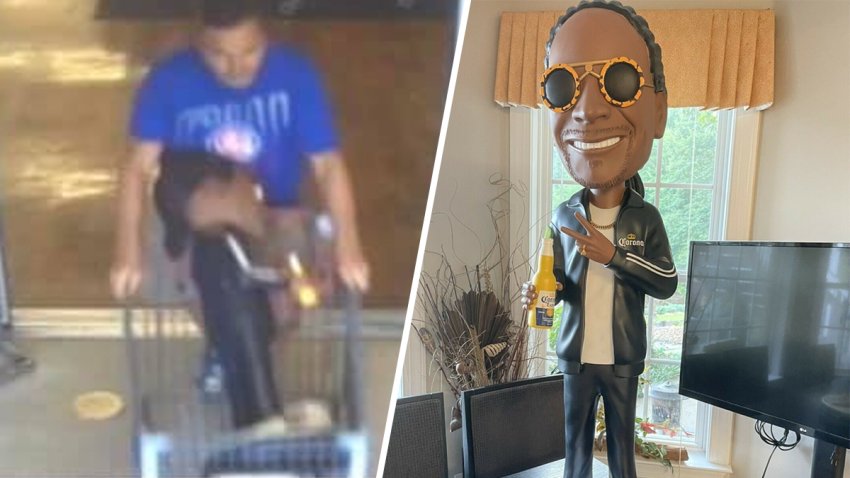 Left: A man wearing a blue t-shirt is seen walking out of a sore while pushing a shopping cart with a 3-foot-tall Snoop Dogg bobblehead inside. Right: The bobblehead is shown smiling, flashing a peace sign and holding a bottle of Corona beer.