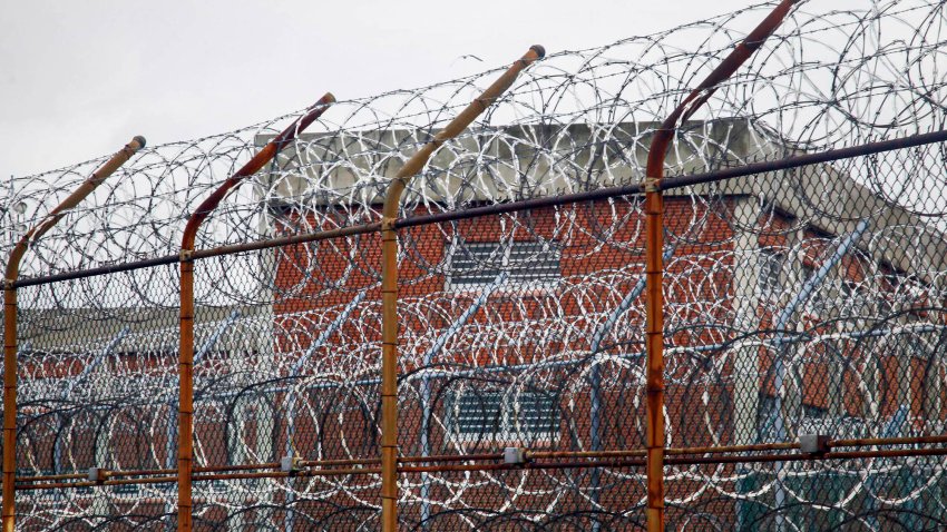 This March 16, 2011 file photo shows a barbed wire fence outside inmate housing on New York's Rikers Island correctional facility in New York