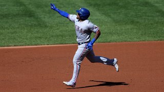 Andy Ibanez #77 of the Texas Rangers celebrates after hitting a two RBI home run against the Baltimore Orioles in the fourth inning at Oriole Park at Camden Yards on Sept. 26, 2021 in Baltimore, Maryland.