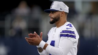 Quarterback Dak Prescott #4 of the Dallas Cowboys looks on from the sidelines as the Dallas Cowboys take on the Houston Texans in the first quarter of a preseason NFL game at AT&T Stadium on Aug. 21, 2021 in Arlington, Texas.