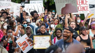 File - Demonstrators chant for the resignation of Glynn County District Attorney Jackie Johnson after a court appearance by Gregory and Travis McMichael on June 4, 2020, in Brunswick, Georgia.