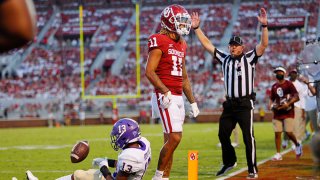 Wide receiver Jadon Haselwood #11 of the Oklahoma Sooners celebrates a touchdown against cornerback Ronald Kent #13 of the Western Carolina Catamounts late in the second quarter at Gaylord Family Oklahoma Memorial Stadium on September 11, 2021 in Norman, Oklahoma. Oklahoma leads 45-0 at the half.