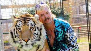 Joe Exotic poses with a tiger