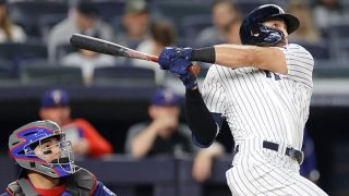 Joey Gallo #13 of the New York Yankees hits a solo home run during the sixth inning against the Texas Rangers at Yankee Stadium on Sept. 21, 2021 in the Bronx borough of New York City.