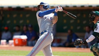 Jonah Heim #28 of the Texas Rangers hits a double in the top of the second inning against the Oakland Athletics at RingCentral Coliseum on Sept. 11, 2021 in Oakland, California.
