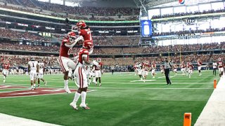 AJ Green #0 of the Arkansas Razorbacks celebrates with teammate Ketron Jackson Jr. #2 after scoring on a touchdown pass against the Texas A&M Aggies in the first half of the Southwest Classic at AT&T Stadium on Sept. 25, 2021 in Arlington, Texas.