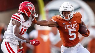 Bijan Robinson #5 of the Texas Longhorns gives a stiff arm to AJ Washington #16 of the Louisiana Ragin' Cajuns in the second half at Darrell K Royal-Texas Memorial Stadium on Sept. 4, 2021 in Austin, Texas.