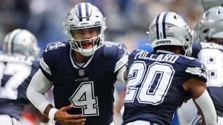 Quarterback Dak Prescott (4) of the Dallas Cowboys hands the ball to running back Tony Pollard (20) of the Dallas Cowboys during the first quarter in the game against the Los Angeles Chargers at SoFi Stadium on Sept. 19, 2021 in Inglewood, California.