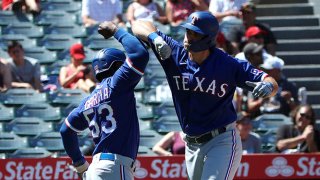 DJ Peters #38 of the Texas Rangers celebrates his three-run home run with Adolis Garcia #53 during the third inning against the Los Angeles Angels at Angel Stadium of Anaheim on Sept. 5, 2021 in Anaheim, California.