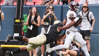 Isaiah Spiller #28 of the Texas A&M Aggies catches the winning touchdown pass while being defended by Guy Thomas #1 of the Colorado Buffaloes during the fourth quarter at Empower Field At Mile High on Sept. 11, 2021 in Denver, Colorado. The Texas A&M Aggies beat the Colorado Buffaloes 10-7.