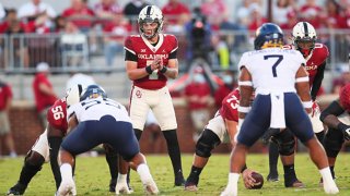 Oklahoma Sooners QB Spencer Rattler (07) calls the signals during a game between the Oklahoma Sooners and the West Virginia Mountaineers on September 25, 2021, at Gaylord Memorial Stadium in Norman, Oklahoma.