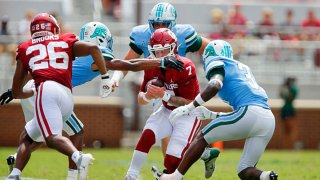 Quarterback Spencer Rattler #7 of the Oklahoma Sooners gets boxed in by safety Macon Clark #37, safety Larry Brooks #31 and defensive end Noah Seiden #91 of the Tulane Green Wave in the third quarter at Gaylord Family Oklahoma Memorial Stadium on Sept. 4, 2021 in Norman, Oklahoma. The Sooners won 40-35.