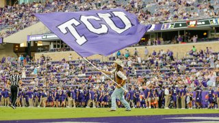 A TCU Horned Frogs flag runner waves a TCU flag during the game between the TCU Horned Frogs and the Duquesne Dukes on Sept. 4, 2021 at Amon G. Carter Stadium in Fort Worth, Texas.