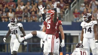 Tre Williams #55 of the Arkansas Razorbacks reacts after taking down Zach Calzada #10 of the Texas A&M Aggies in the first half of the Southwest Classic at AT&T Stadium on Sept. 25, 2021 in Arlington, Texas. Arkansas won 20-10.