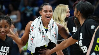 Satou Sabally #0 of the Dallas Wings celebrates clinching a playoff spot after the game against the New York Liberty on September 11, 2021 at the College Park Center in Arlington, Texas.