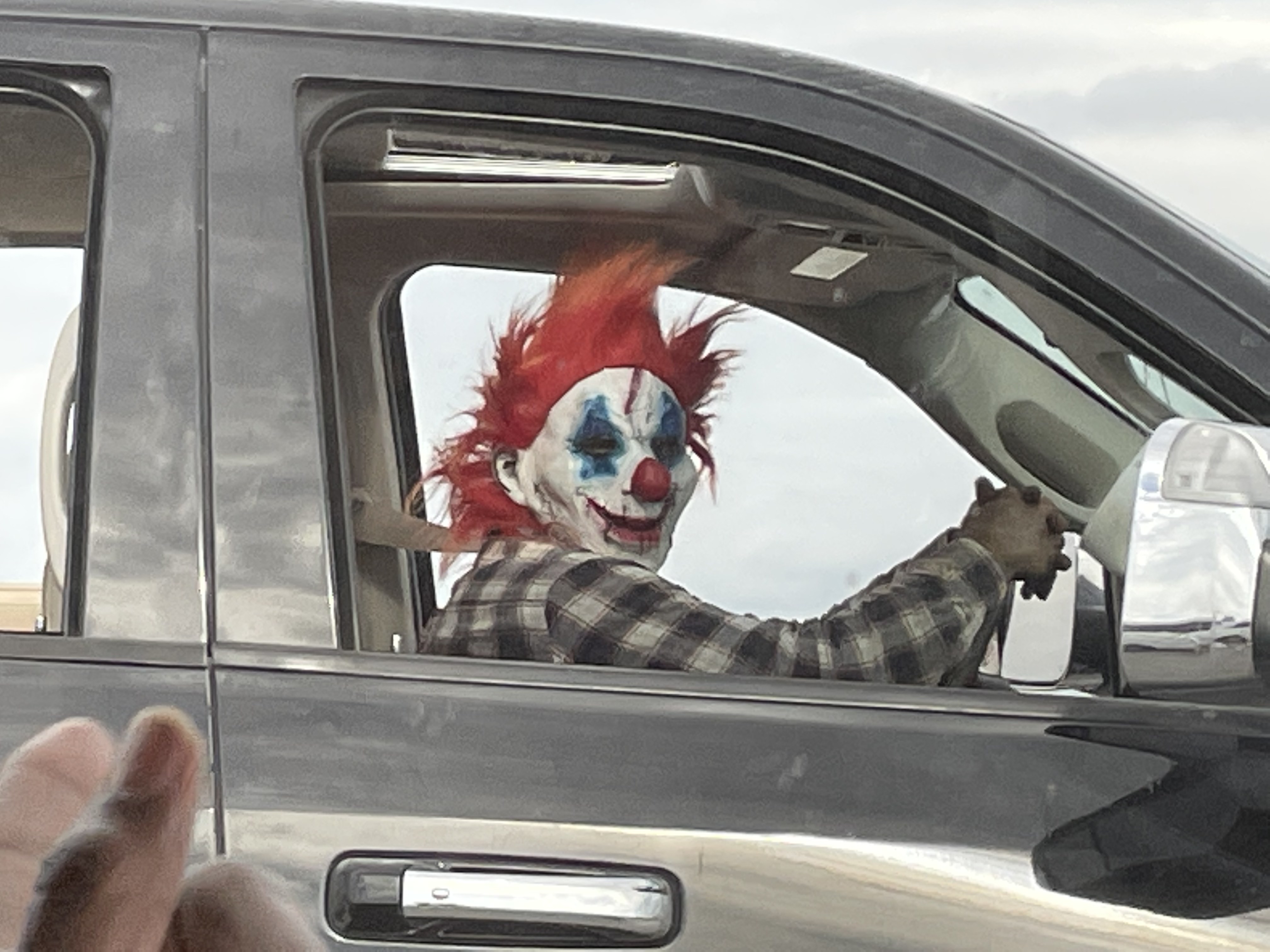 As my Mom was driving us southbound on I-45 near downtown Dallas circa 4pm, she notice an evil clown in the rear view mirror. I snapped a shot when he (or “It” 🤡) was behind us, and again when beside us. Evil Clown Commuter, you made our day!!