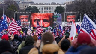 FILE - In this Jan. 6, 2021, file photo, the face of President Donald Trump appears on large screens as supporters participate in a rally in Washington. The House committee investigating the violent Jan. 6 Capitol insurrection, with its latest round of subpoenas in September 2021, may uncover the degree to which former President Donald Trump, his campaign and White House were involved in planning the rally that preceded the riot, which had been billed as a grassroots demonstration.