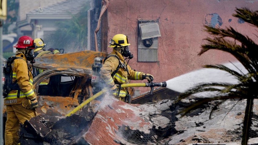Fire crews work the scene of a plane crash