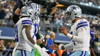 Dak Prescott #4 of the Dallas Cowboys celebrates with Ezekiel Elliott #21 after he ran for a touchdown during the third quarter against the New York Giants at AT&T Stadium on Oct. 10, 2021 in Arlington, Texas.