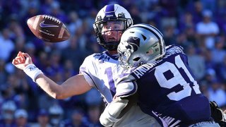 Quarterback Chandler Morris #14 of the TCU Horned Frogs fumbles the ball after getting hit by defensive end Felix Anudike-Uzomah #91 of the Kansas State Wildcats, during the second half at Bill Snyder Family Football Stadium on Oct. 30, 2021 in Manhattan, Kansas.