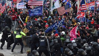FILE - Trump supporters clash with police and security forces as they push barricades to storm the U.S. Capitol in Washington, D.C., Jan. 6, 2021.
