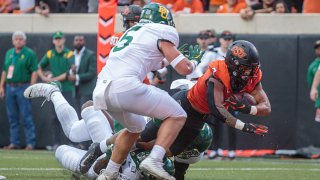 Oklahoma State Cowboys running back Jaylen Warren (7) dives for the end zone for a touchdown against the Baylor Bears on Oct. 2, 2021 at Boone Pickens Stadium in Stillwater, Oklahoma.