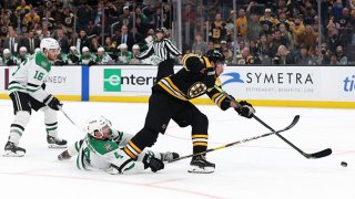 Brad Marchand #63 of the Boston Bruins scores a goal past Miro Heiskanen #4 of the Dallas Stars during the third period of the Bruins home opener at TD Garden on Oct. 16, 2021 in Boston, Massachusetts.