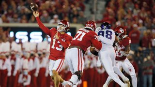 Quarterback Caleb Williams #13 of the Oklahoma Sooners throws a long pass to wide receiver Marvin Mims against the Texas Christian University Horned Frogs late in the second quarter at Gaylord Family Oklahoma Memorial Stadium on Oct. 16, 2021 in Norman, Oklahoma.