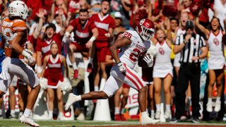 Kennedy Brooks #26 of the Oklahoma Sooners scores a touchdown in the fourth quarter against the Texas Longhorns during the 2021 AT&T Red River Showdown at Cotton Bowl on Oct. 9, 2021 in Dallas, Texas.