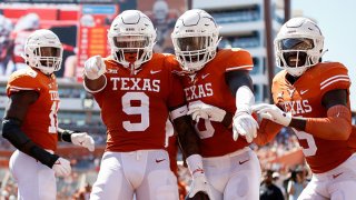 Josh Thompson #9 of the Texas Longhorns celebrates with teammates after an interception return for a touchdown in the second quarter against the Texas Tech Red Raiders at Darrell K Royal-Texas Memorial Stadium on Sept. 25, 2021 in Austin, Texas.