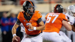 Oklahoma State Cowboys quarterback Spencer Sanders (3) scrambles in the back field against the Kansas Jayhawks on Oct. 30, 2021 at Boone Pickens Stadium in Stillwater, Oklahoma.