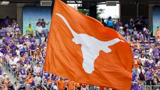 A Texas Longhorns flag runner flies the Texas flag after a touchdown during the game between the TCU Horned Frogs and the Texas Longhorns on Oct. 2, 2021 at Amon G. Carter Stadium in Fort Worth, Texas.