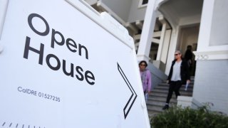 Real estate agents leave a home for sale during a broker open house in San Francisco, California.