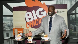 Shaquille O’Neal, NBA star and Carnival Cruise Line’s Chief Fun Officer, gives guests a taste of his highly-anticipated dishes that will be offered at sea as part of Big Chicken at Mardi Gras’ Summer Landing zone during Carnival Cruise Line’s NYC Cruise Into Summer Event To Celebrate The Arrival Of Mardi Gras In 2020 at Pier 59 on June 18, 2019 in New York City.