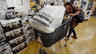 Customers carry bags from Bed Bath & Beyond store on April 10, 2013 in Los Angeles, California.