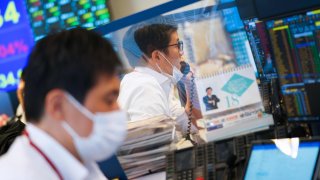 Employees work in the trading room at the Daiwa Securities Group Inc. headquarters in Tokyo, Japan, on Thursday, Oct. 14, 2021.