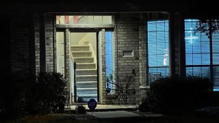 Jose Torres's residence with the door open while police investigate.