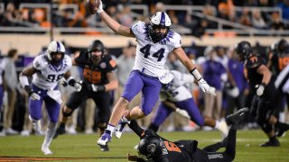 TCU defensive end Colt Ellison (44) leaps to escape an ankle tackle by Oklahoma State quarterback Ethan Bullock (6)